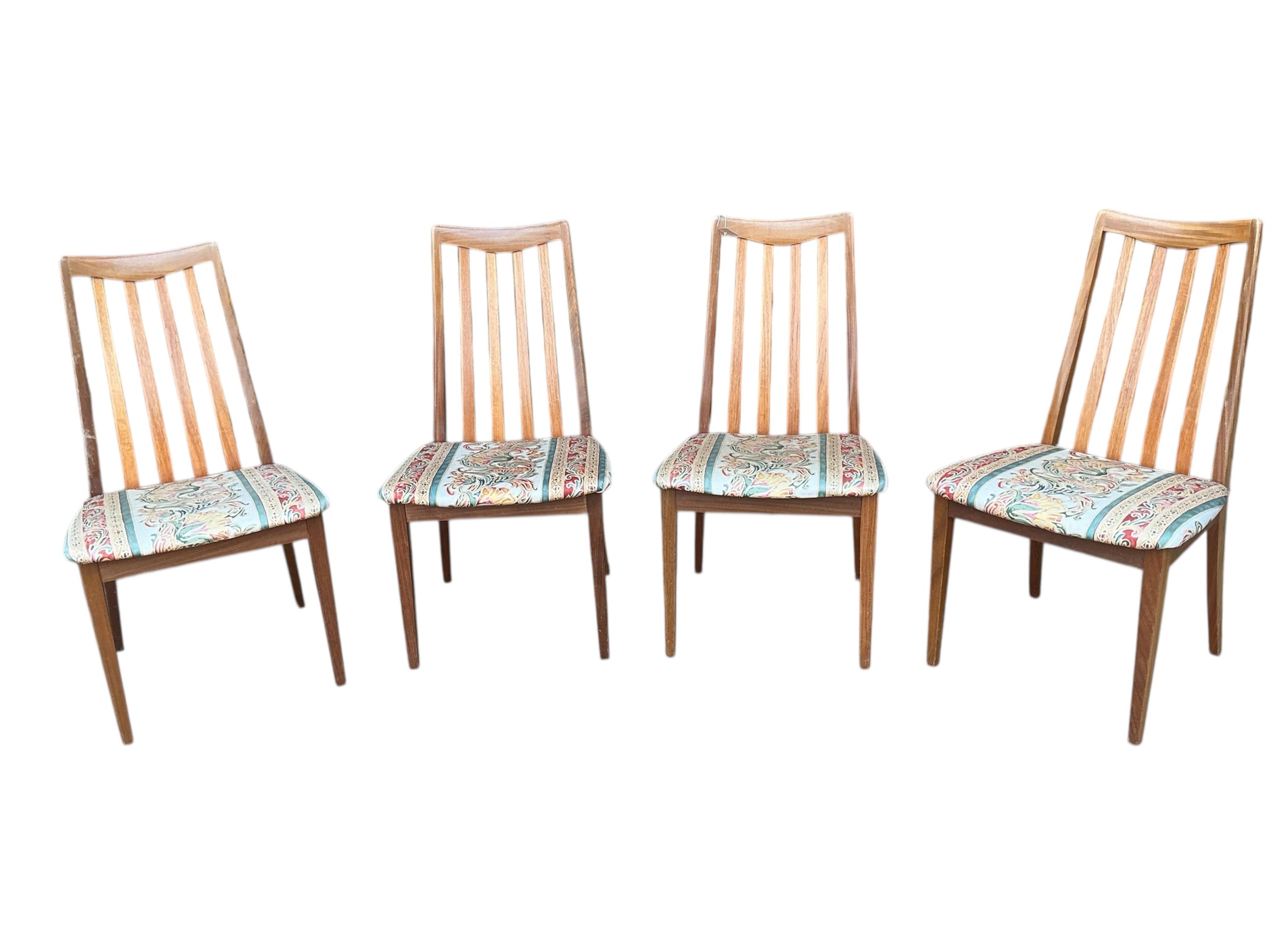 A mid century G Plan Fresco teak extending dining table, diameter 160cm, height 74cm, and four chairs